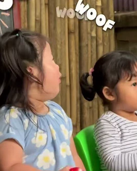 Two little girls listening during the workshop